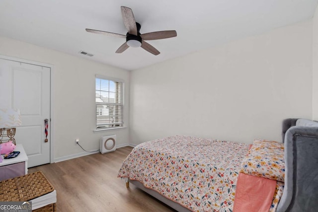 bedroom with hardwood / wood-style flooring and ceiling fan