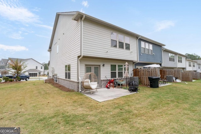 rear view of property featuring a patio area and a lawn