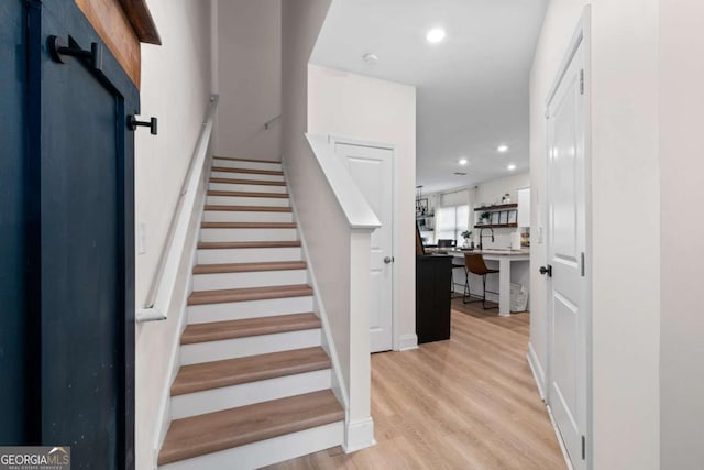 stairs with hardwood / wood-style floors