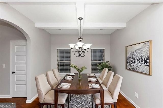 dining space with dark hardwood / wood-style floors, coffered ceiling, a chandelier, and beam ceiling