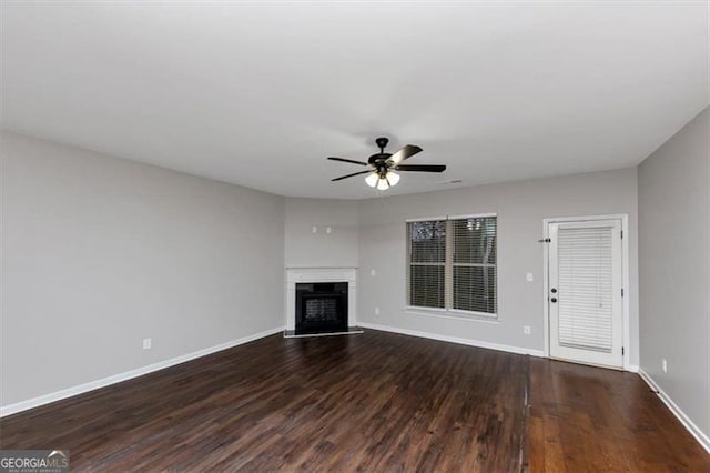 unfurnished living room with ceiling fan and dark hardwood / wood-style floors