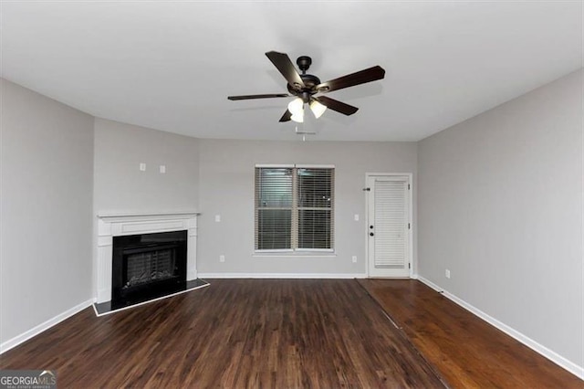 unfurnished living room with ceiling fan and dark hardwood / wood-style floors