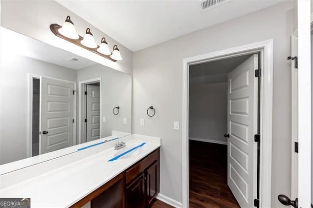 bathroom with vanity and wood-type flooring