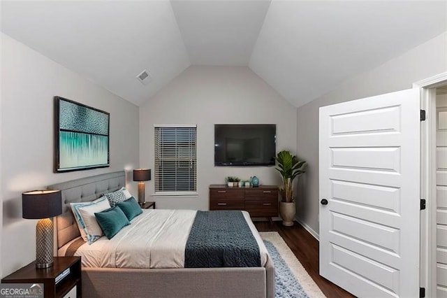 bedroom with lofted ceiling and dark hardwood / wood-style flooring