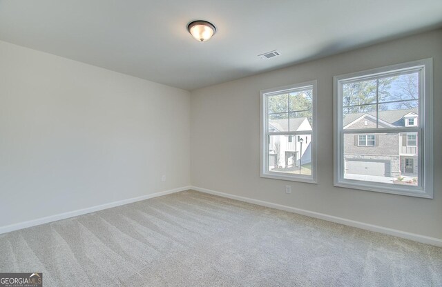 empty room featuring light carpet