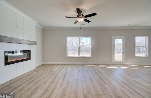 unfurnished living room with ornamental molding, ceiling fan, a fireplace, and light hardwood / wood-style floors