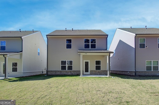 back of property with a yard and a patio area