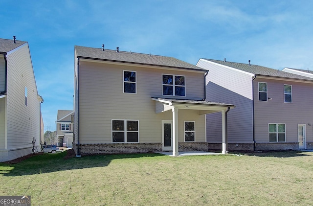 rear view of property with a yard