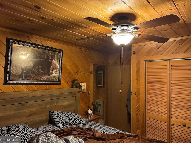 bedroom with wood ceiling, ceiling fan, and wood walls