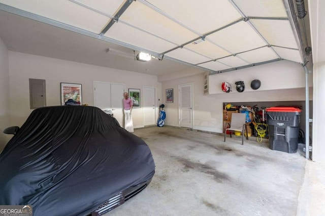 garage featuring a garage door opener and electric panel