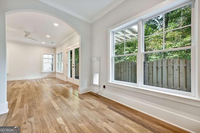 interior space with ornamental molding and light hardwood / wood-style floors