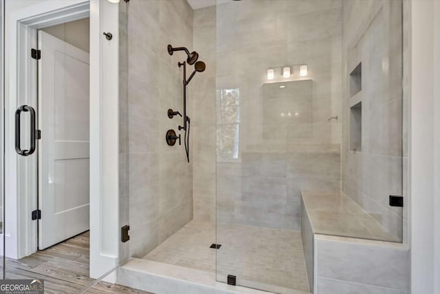 bathroom with wood-type flooring and walk in shower