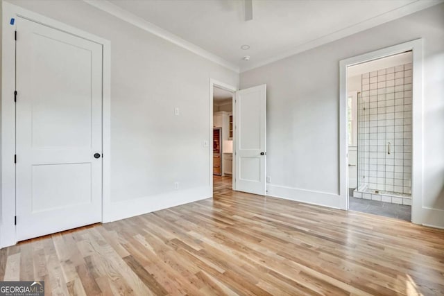 unfurnished bedroom featuring light wood-type flooring, ornamental molding, ceiling fan, and ensuite bathroom