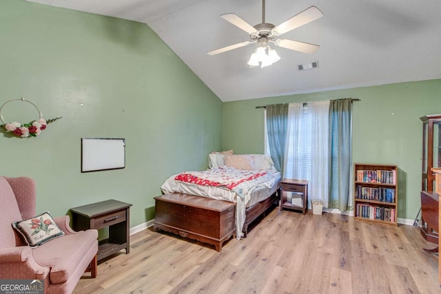 bedroom featuring ceiling fan, lofted ceiling, and light hardwood / wood-style flooring