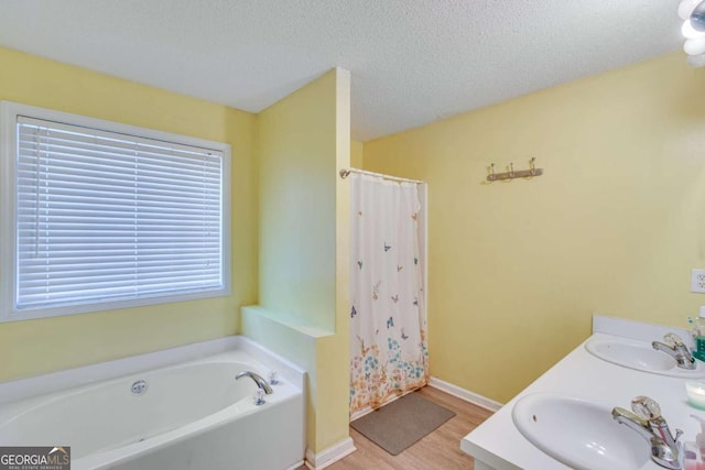 bathroom with vanity, shower with separate bathtub, wood-type flooring, and a textured ceiling