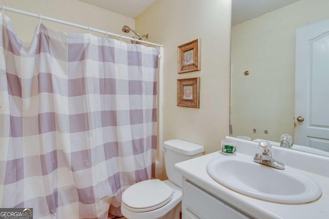 full bathroom featuring vanity, shower / tub combo, a textured ceiling, and toilet