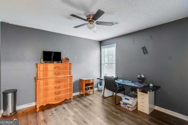 office with ceiling fan, wood-type flooring, and a textured ceiling