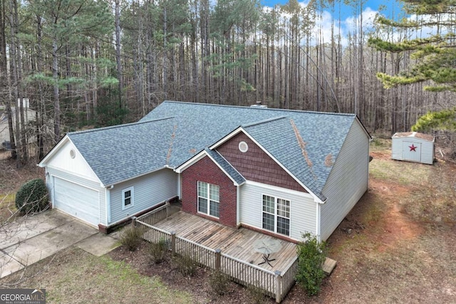 view of front of house featuring a wooden deck and a storage shed