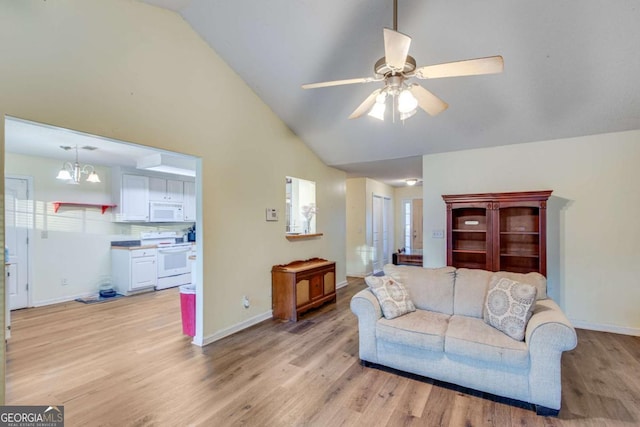 living room featuring lofted ceiling, ceiling fan with notable chandelier, and light wood-type flooring