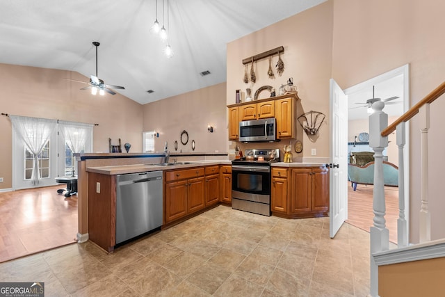 kitchen with sink, high vaulted ceiling, appliances with stainless steel finishes, kitchen peninsula, and ceiling fan