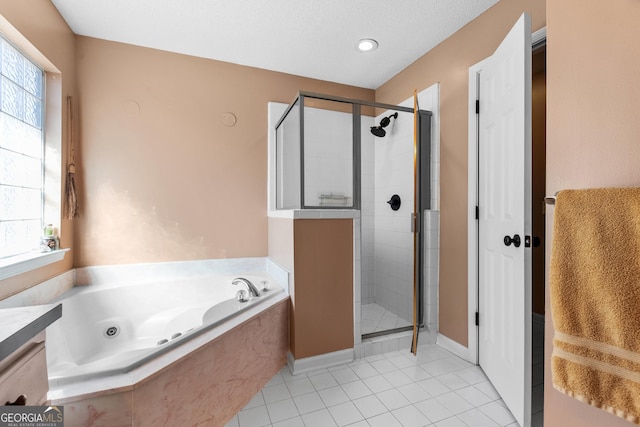 bathroom with tile patterned flooring, vanity, separate shower and tub, and a textured ceiling