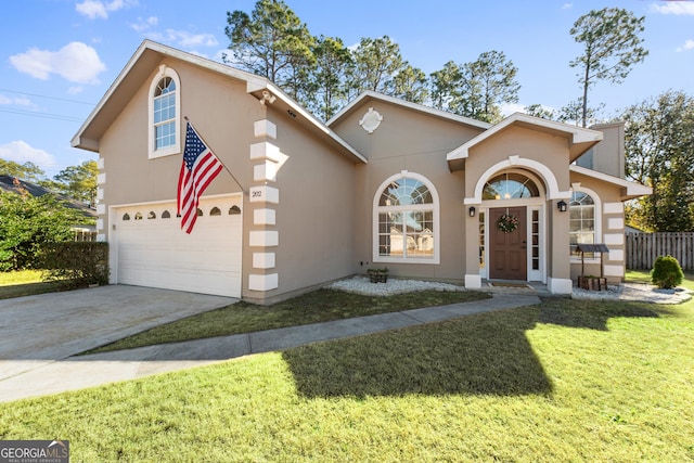 view of front of property with a garage and a front lawn