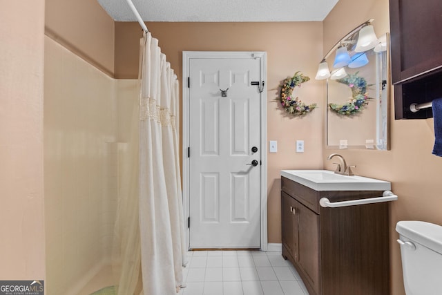 bathroom with tile patterned floors, toilet, a textured ceiling, vanity, and curtained shower