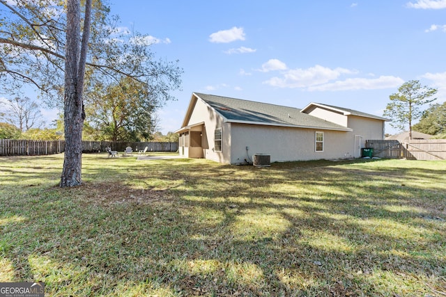 view of home's exterior with a yard and central AC unit