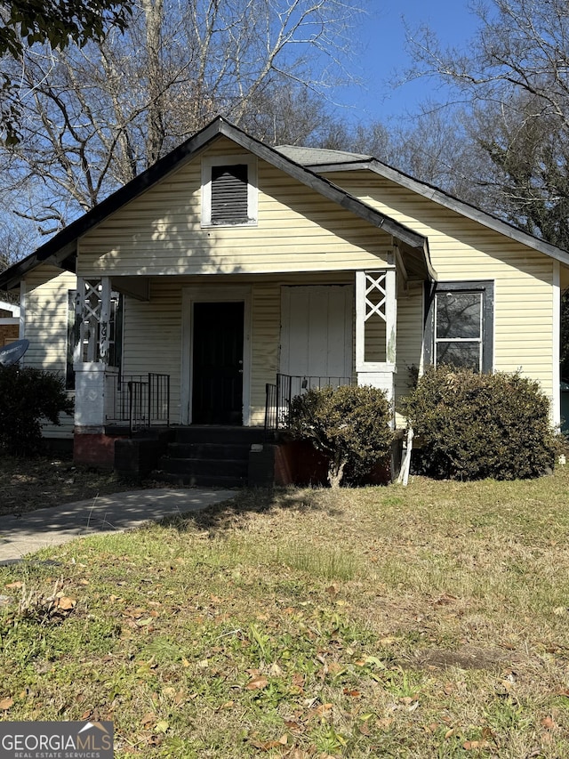 bungalow-style house featuring a front yard and a porch