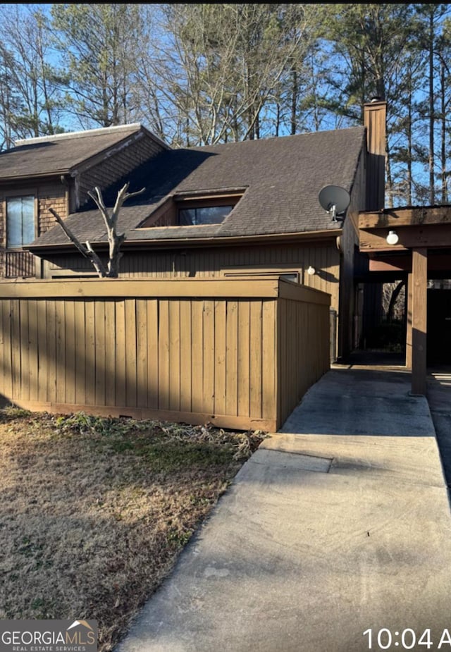 view of property exterior with a carport