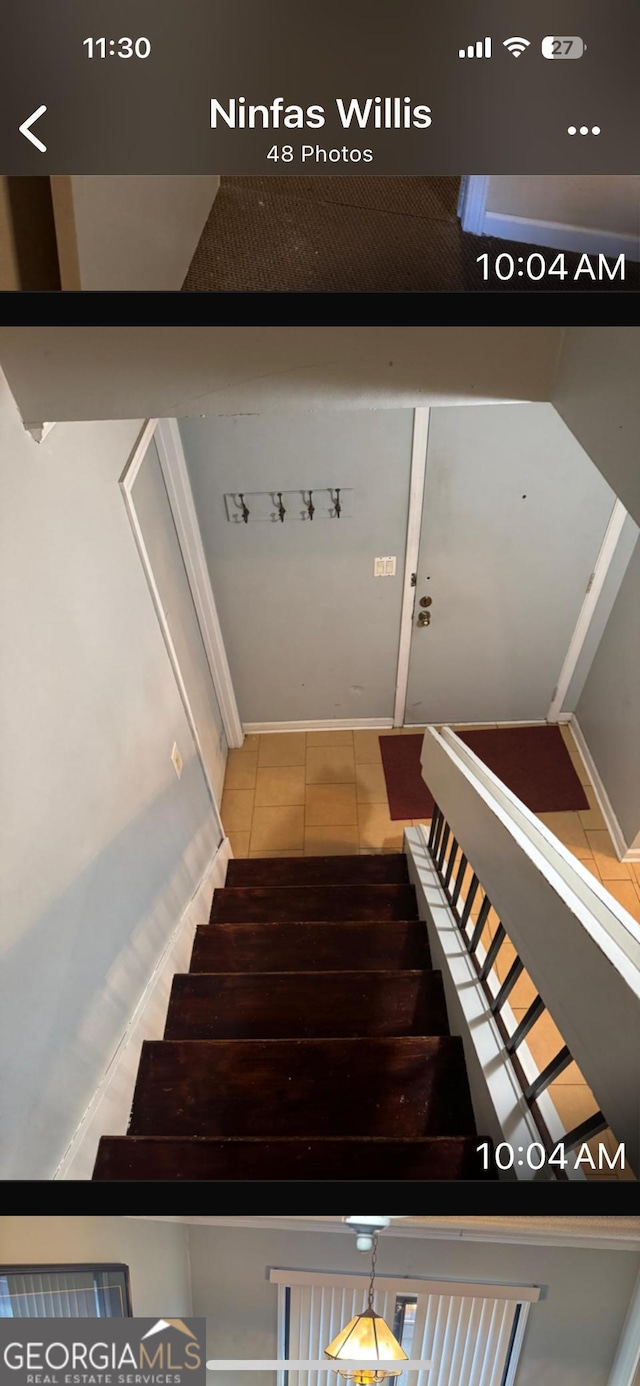 stairway with tile patterned flooring