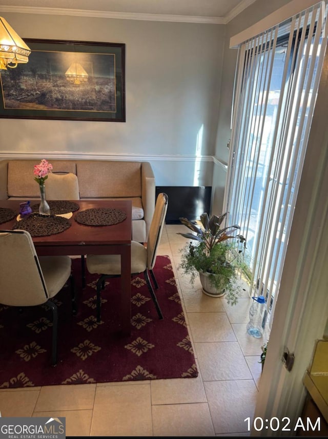 tiled dining room with ornamental molding