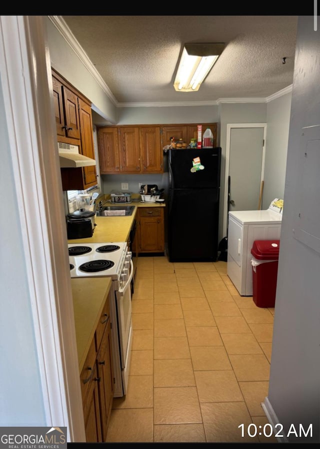 kitchen with sink, white range with electric stovetop, ornamental molding, washer and dryer, and black fridge