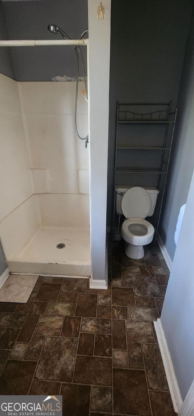 bathroom with walk in shower and toilet