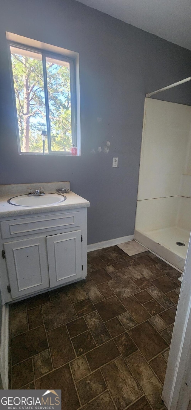 bathroom featuring vanity and a shower