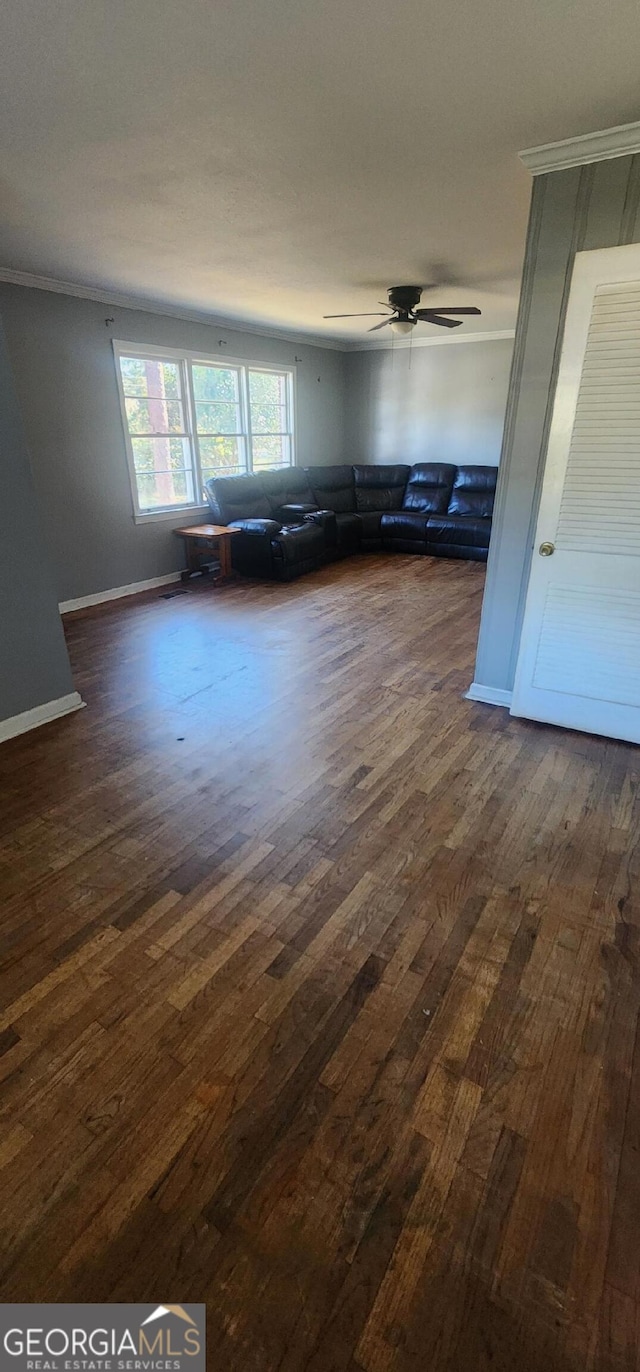 unfurnished living room with dark wood-type flooring and ceiling fan