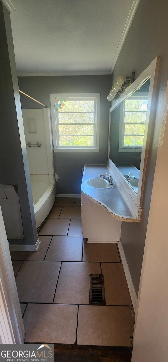 bathroom featuring ornamental molding, tile patterned floors, and vanity