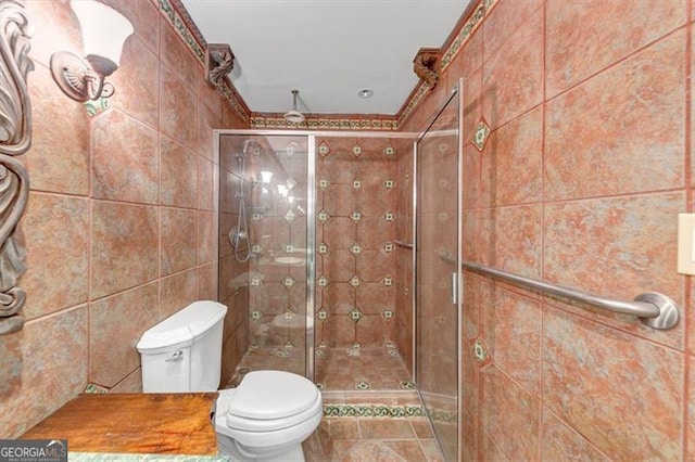 bathroom with toilet, tile walls, and walk in shower