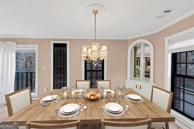 dining space featuring light tile patterned flooring, ornamental molding, and a chandelier