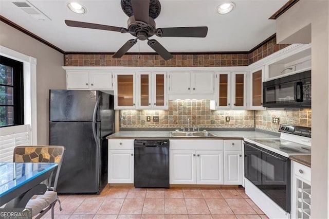 kitchen with white cabinetry, sink, black appliances, and light tile patterned flooring