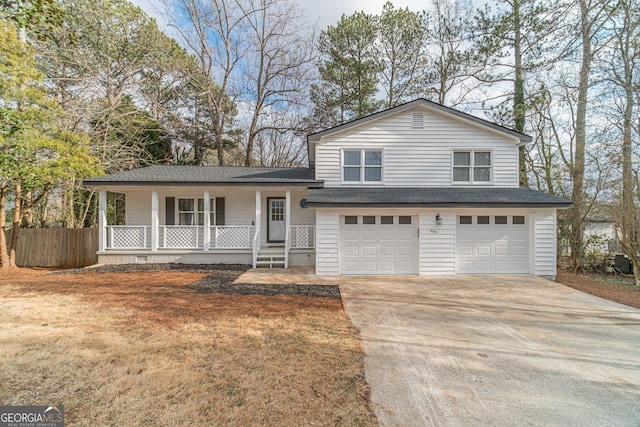 tri-level home featuring roof with shingles, a porch, concrete driveway, fence, and a garage