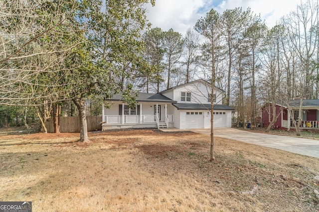 split level home featuring a porch and concrete driveway