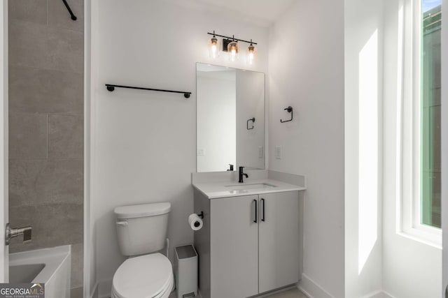 full bathroom with vanity, tiled shower / bath, and toilet