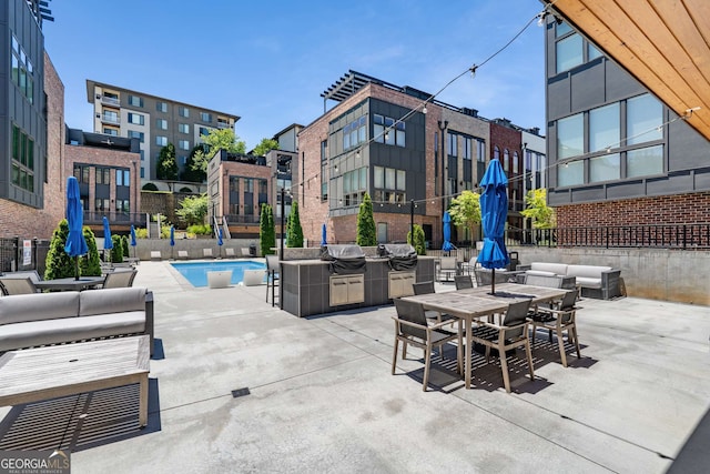 view of patio with area for grilling and a community pool