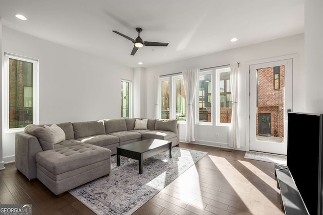 living room featuring ceiling fan, a fireplace, and hardwood / wood-style floors