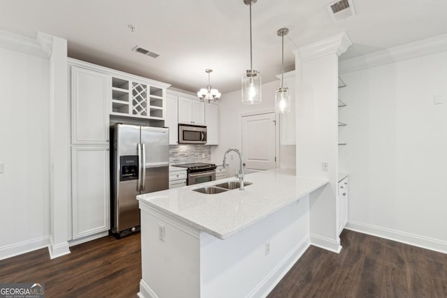 kitchen with white cabinetry, hanging light fixtures, stainless steel appliances, and kitchen peninsula