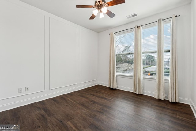 empty room featuring ceiling fan and dark hardwood / wood-style flooring