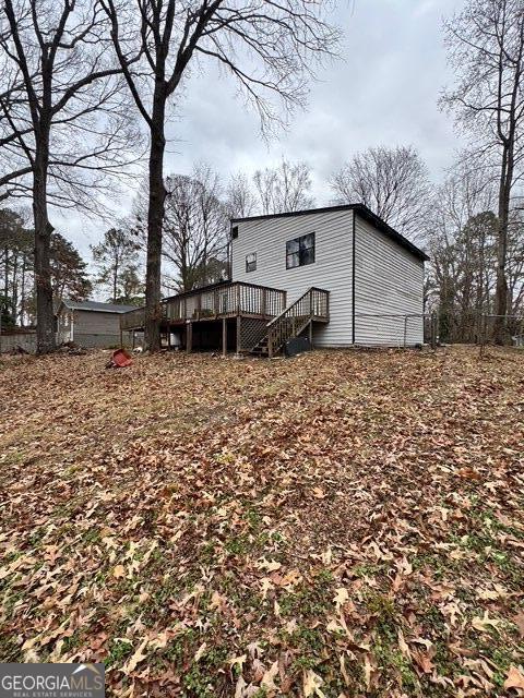 back of house with a deck