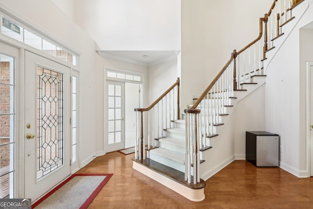 entryway with hardwood / wood-style flooring and ornamental molding