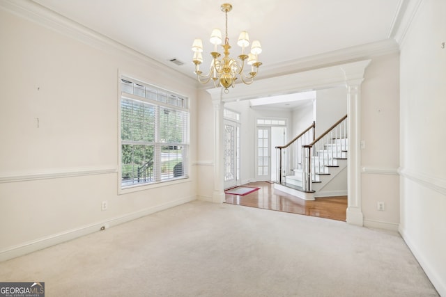 interior space with ornamental molding, decorative columns, and a chandelier